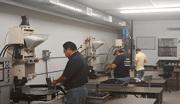 A group of people working in a machine shop.